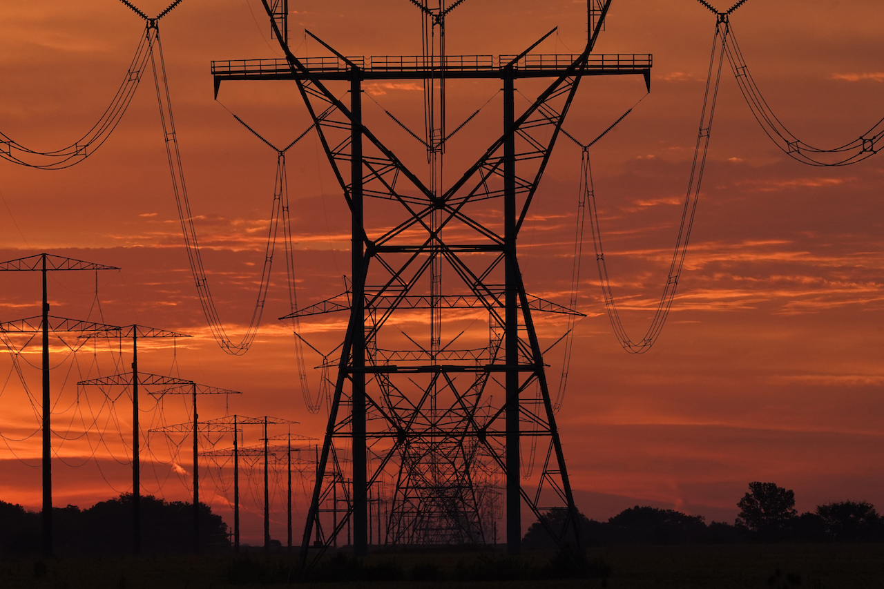 The sun begins to rise near power lines Saturday, Sept. 16, 2023, near Monee, Ill. (AP Photo/Charles Rex Arbogast)